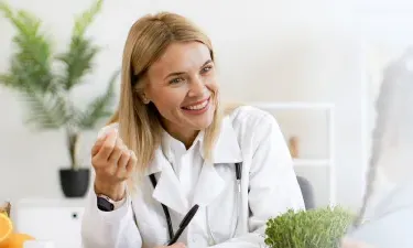 Alaska family nurse practitioner smiling with pediatric patient during appointment